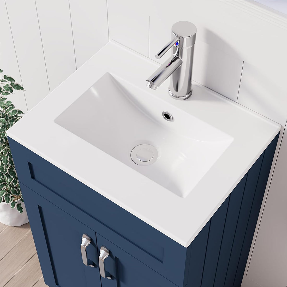 Close-up of white integrated sink with chrome faucet on 500mm navy blue vanity unit