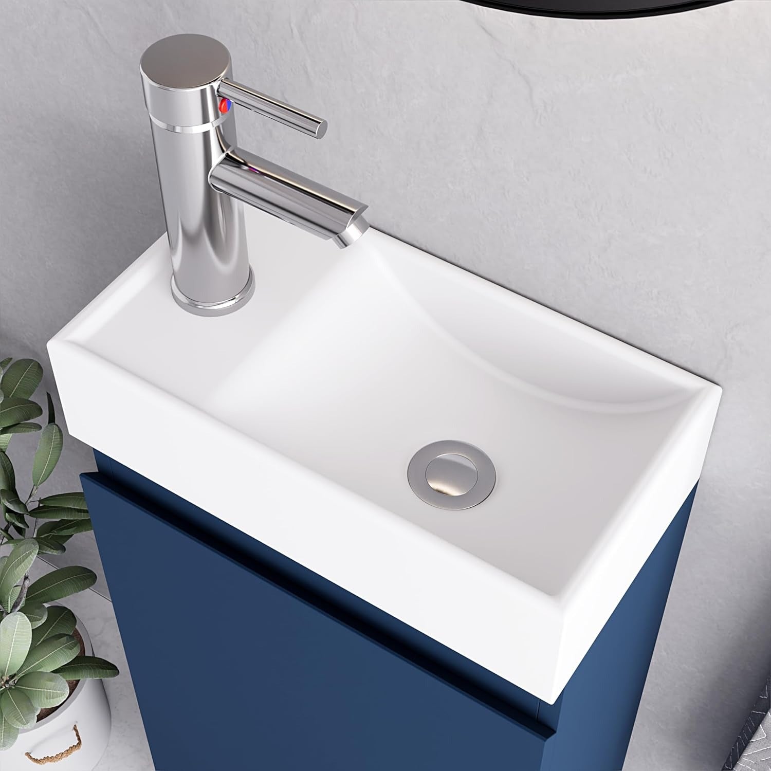 Close-up of white rectangular sink with chrome faucet on inky blue 400mm vanity unit