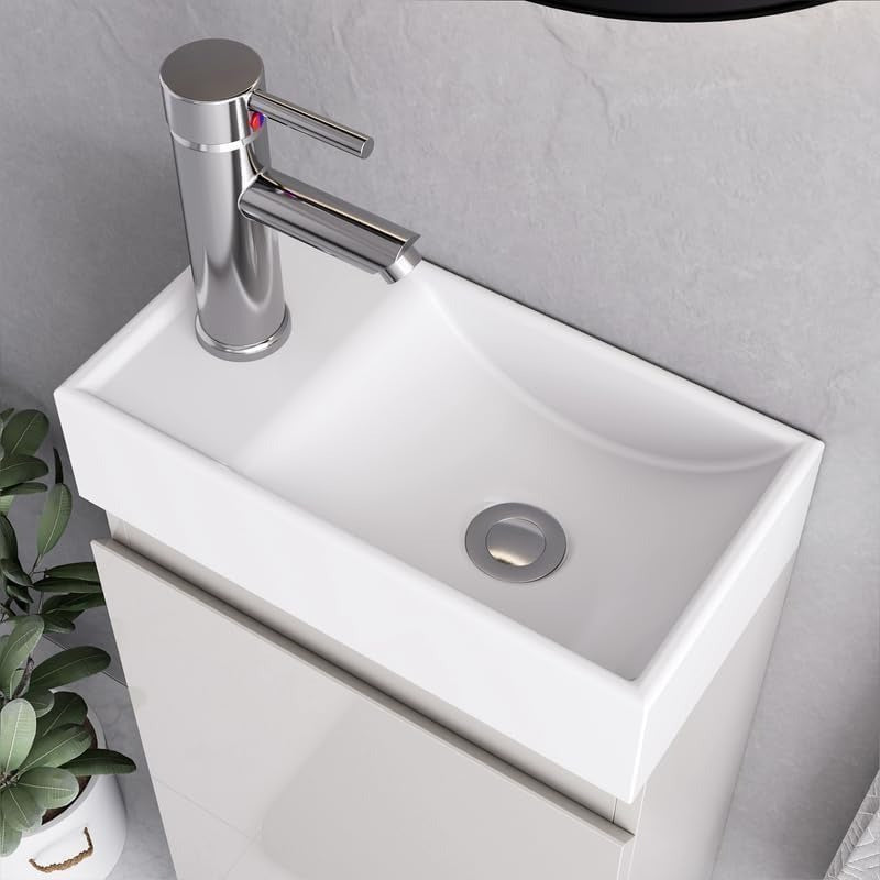Close-up of white rectangular sink with chrome faucet on white gloss 400mm vanity unit