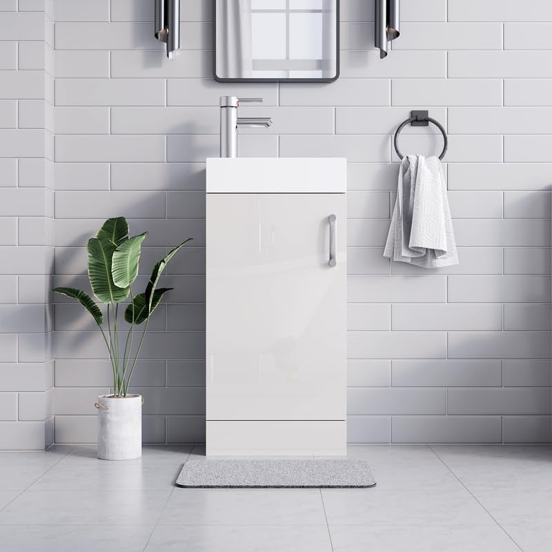 White gloss vanity unit 400mm with white ceramic sink and chrome faucet in white tiled bathroom