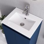 Close-up of white integrated sink with chrome faucet on 500mm dark blue vanity unit