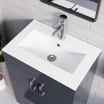 Close-up of white integrated sink with chrome faucet on 500mm grey gloss vanity unit