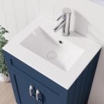 Close-up of white integrated sink with chrome faucet on 500mm navy blue vanity unit