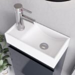 Close-up of white rectangular sink with chrome faucet on grey gloss 400mm vanity unit