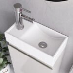 Close-up of white rectangular sink with chrome faucet on white gloss 400mm vanity unit