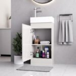 White gloss 400mm vanity unit with open cabinet door showing internal storage shelves and towels