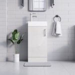 White gloss vanity unit 400mm with white ceramic sink and chrome faucet in white tiled bathroom